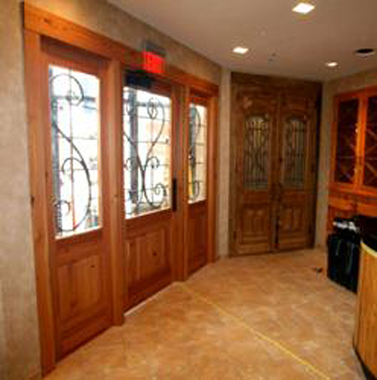 Handcrafted by NEWwoodworks of reclaimed heart pine, doors in the Rochester NY restaurant celebrate crisp grain patterns and rich color tones complimented by wrought iron accents.